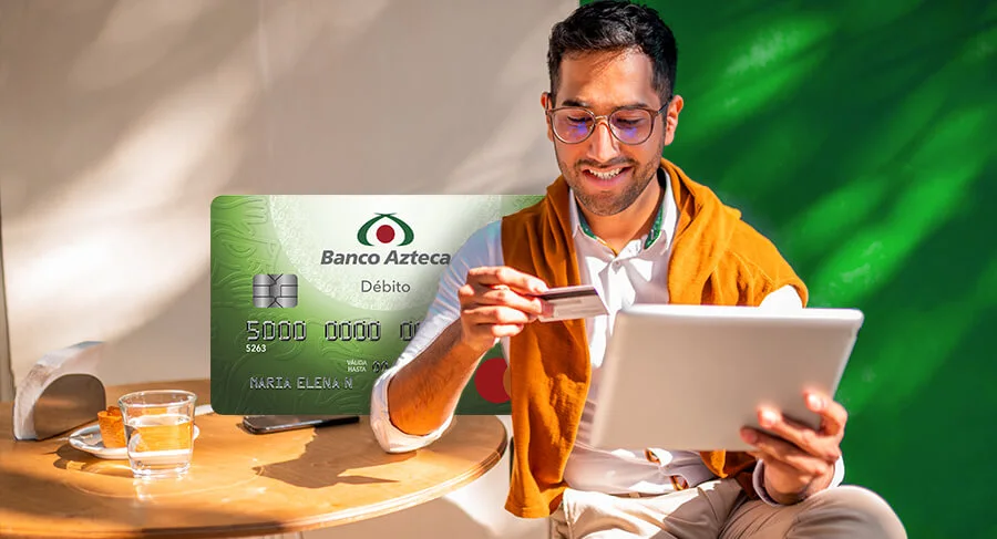 Hombre con gafas usando su tableta y tarjeta de Banco Azteca. Ideal para  quienes buscan una tarjeta de débito sin comisiones ni saldo mínimo.